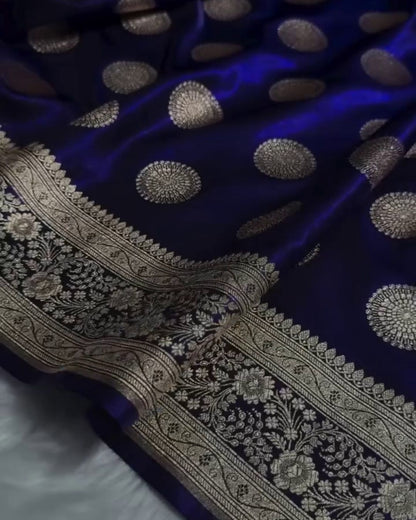 Blue fabric with gold embroidery on a white surface