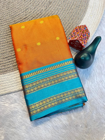 Sunset Orange Aura Silk Saree with Peacock Blue Zari Border & Blouse