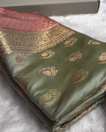Green fabric with gold embroidery on a white surface