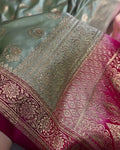 Close-up of a fabric with intricate gold patterns on a green and red background