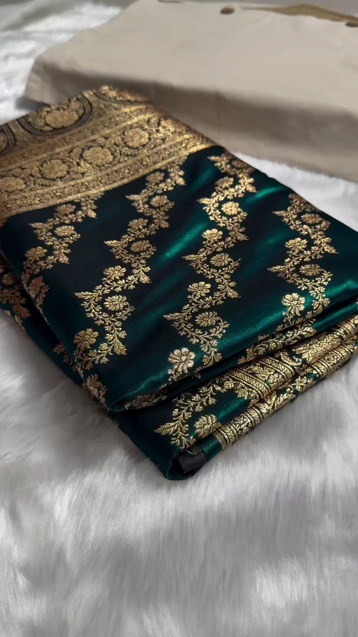 Green fabric with gold embroidery on a white surface