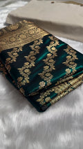Green fabric with gold embroidery on a white surface