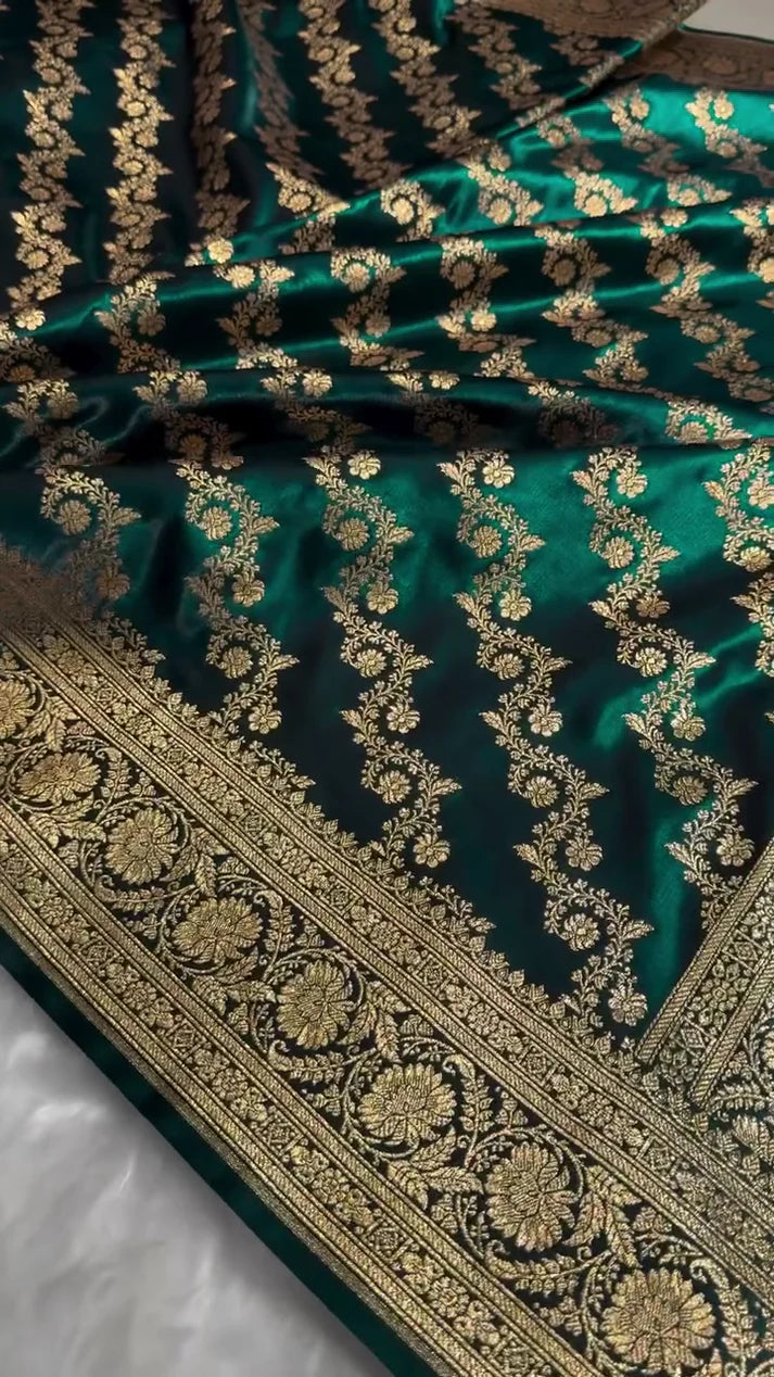 Green fabric with gold embroidery on a white surface