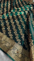 Green fabric with gold embroidery on a plain background