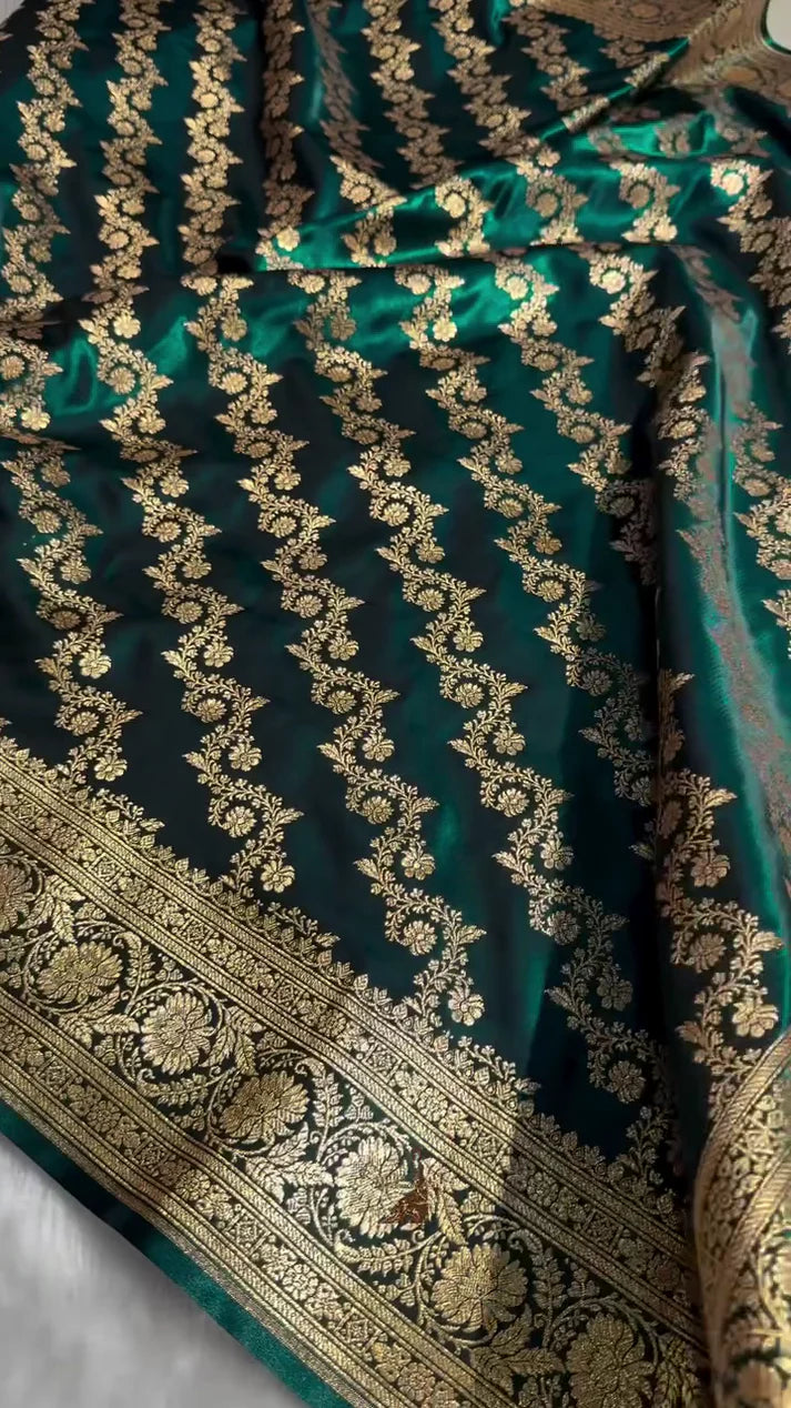 Green fabric with gold embroidery on a plain background
