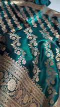Teal fabric with intricate gold embroidery