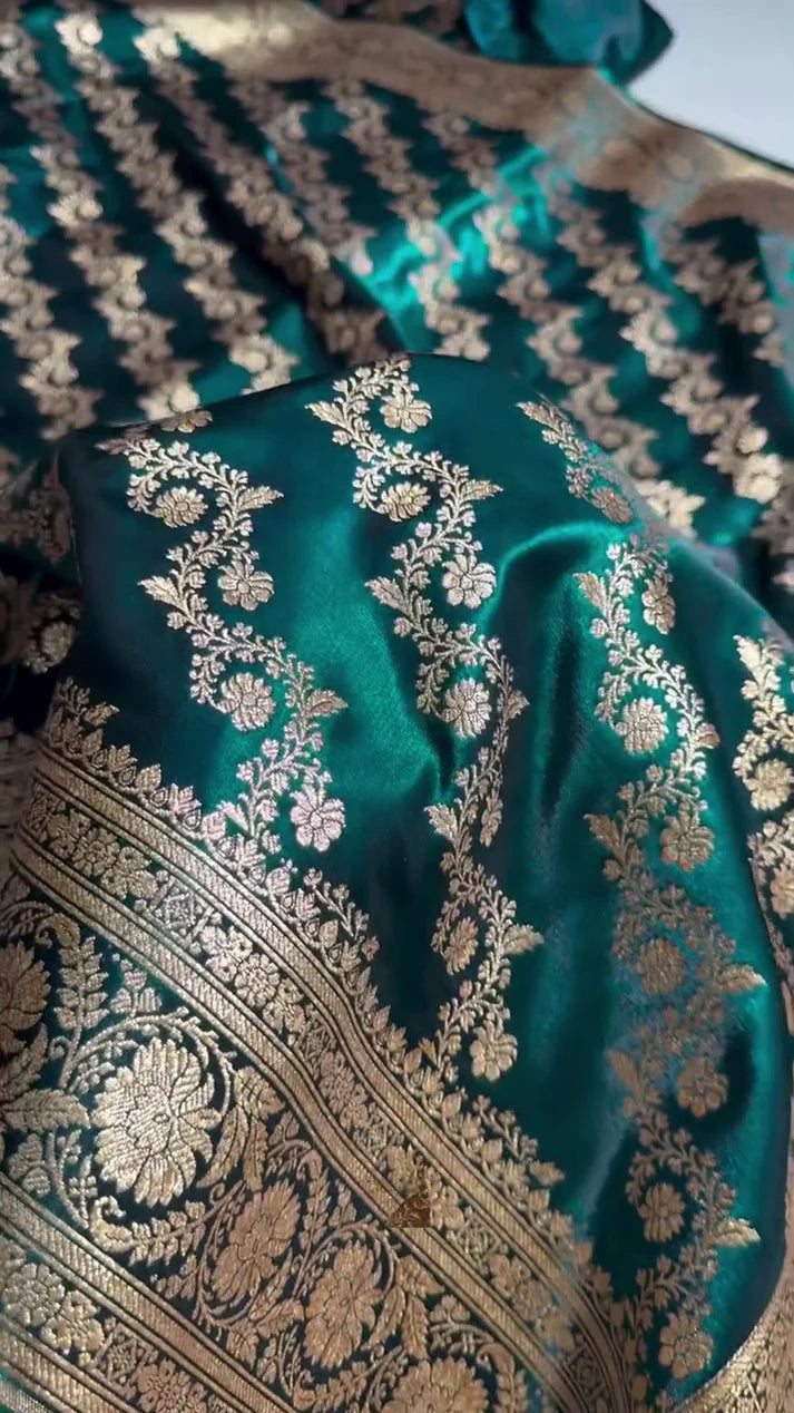 Teal fabric with intricate gold embroidery